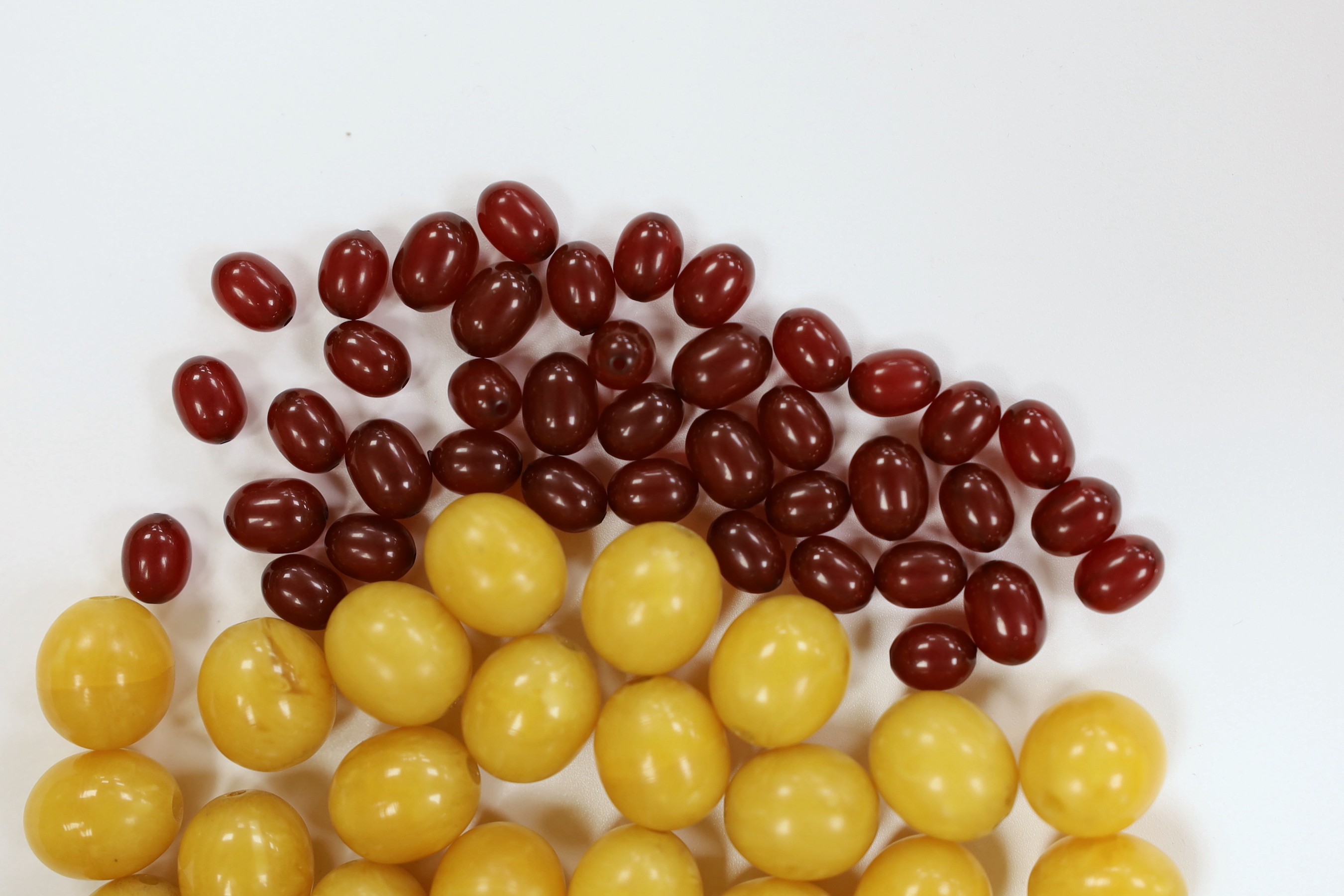 A group of loosed butterscotch amber beads, gross 31 grams, a group of loose yellow amber beads and a group of loose simulated cherry amber beads.